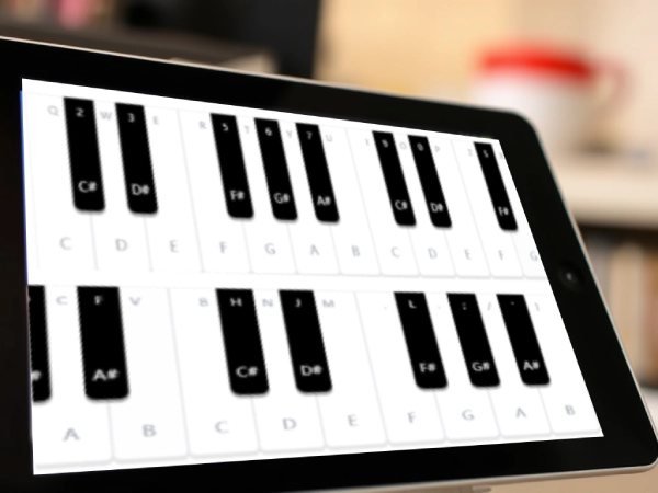 Close-up of virtual piano interface on tablet with guides.